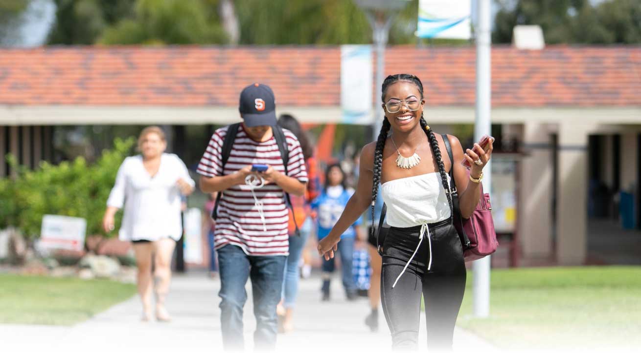 Students walking and laughing on campus