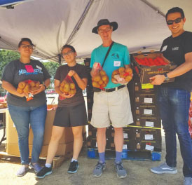 Students holding produce