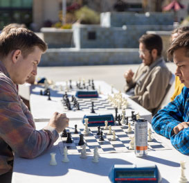 male students playing chess