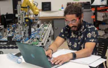 man working on laptop in lab