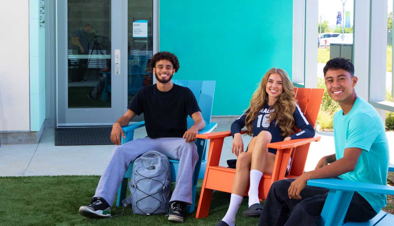 students sit in colorful lawn chairs